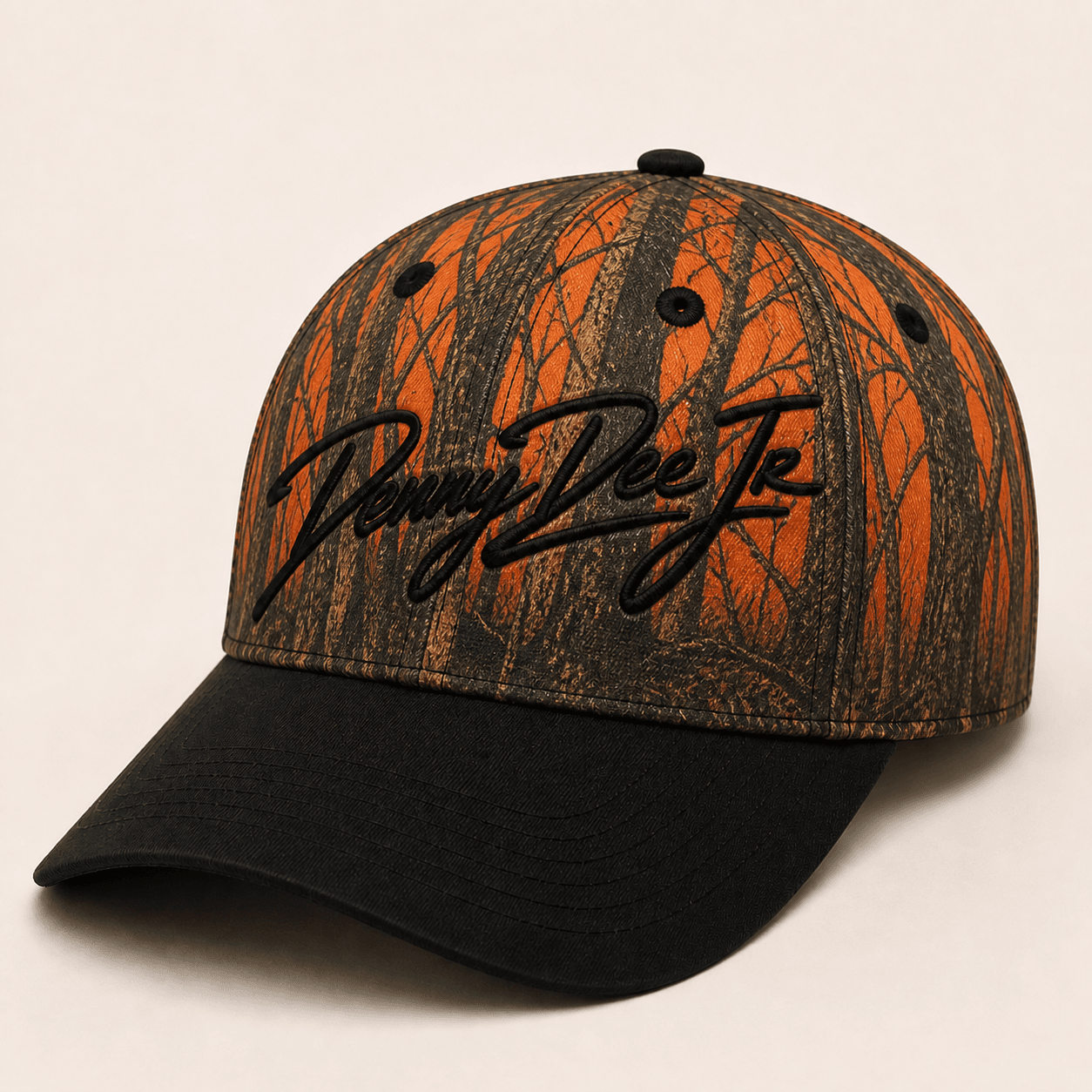 Blaze-orange bottomland-inspired bark camo baseball cap with a black brim and embroidered Denny Dee Jr signature